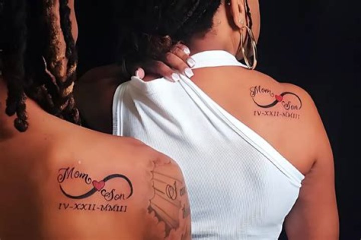 Mother tattoos face of son on her back