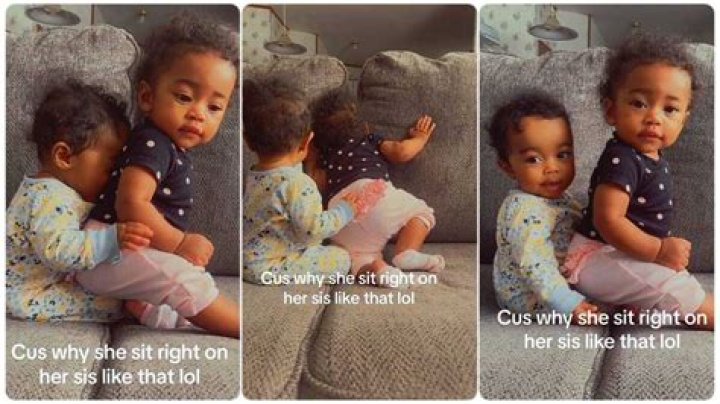 "The Nerve to Sit on Her": Funny Little Baby Sits on the Lap of Her Younger Sister in Video